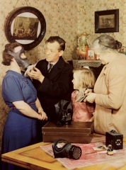 A member of the warden's service fitting a gas mask � John Hinde, courtesy National Media Museum